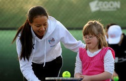 Sports stars coach Down’s tennis team Anne Keothavong with a member of Fulham's Down's syndrome tennis team