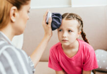 Supporting children with dyspraxia child with dyspraxia who got hurt being comforted by her mother