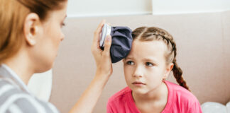 Supporting children with dyspraxia child with dyspraxia who got hurt being comforted by her mother