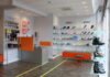 Shoe fitting: Why the correct footwear is paramount for people with autism The inside of a shoe shop, with red accents and shoes lining the wall and a chair for shoe fitting.
