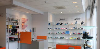 Shoe fitting: Why the correct footwear is paramount for people with autism The inside of a shoe shop, with red accents and shoes lining the wall and a chair for shoe fitting.