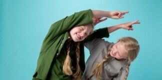Autistic children benefit from dance movement psychotherapy Two girls with long blonde plaits playing together