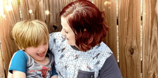 The Challenges of Being an Autistic Mother with Autistic Children A photo of Alicia and her son. They are both wearing short-sleeved shirts and Alicia is smiling at her son
