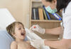 Designing and managing a health testing programme for your school A woman testing a young boy for illness
