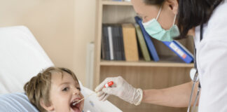 Designing and managing a health testing programme for your school A woman testing a young boy for illness