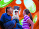 How can inclusive playgrounds support children’s play values and inclusive experiences?